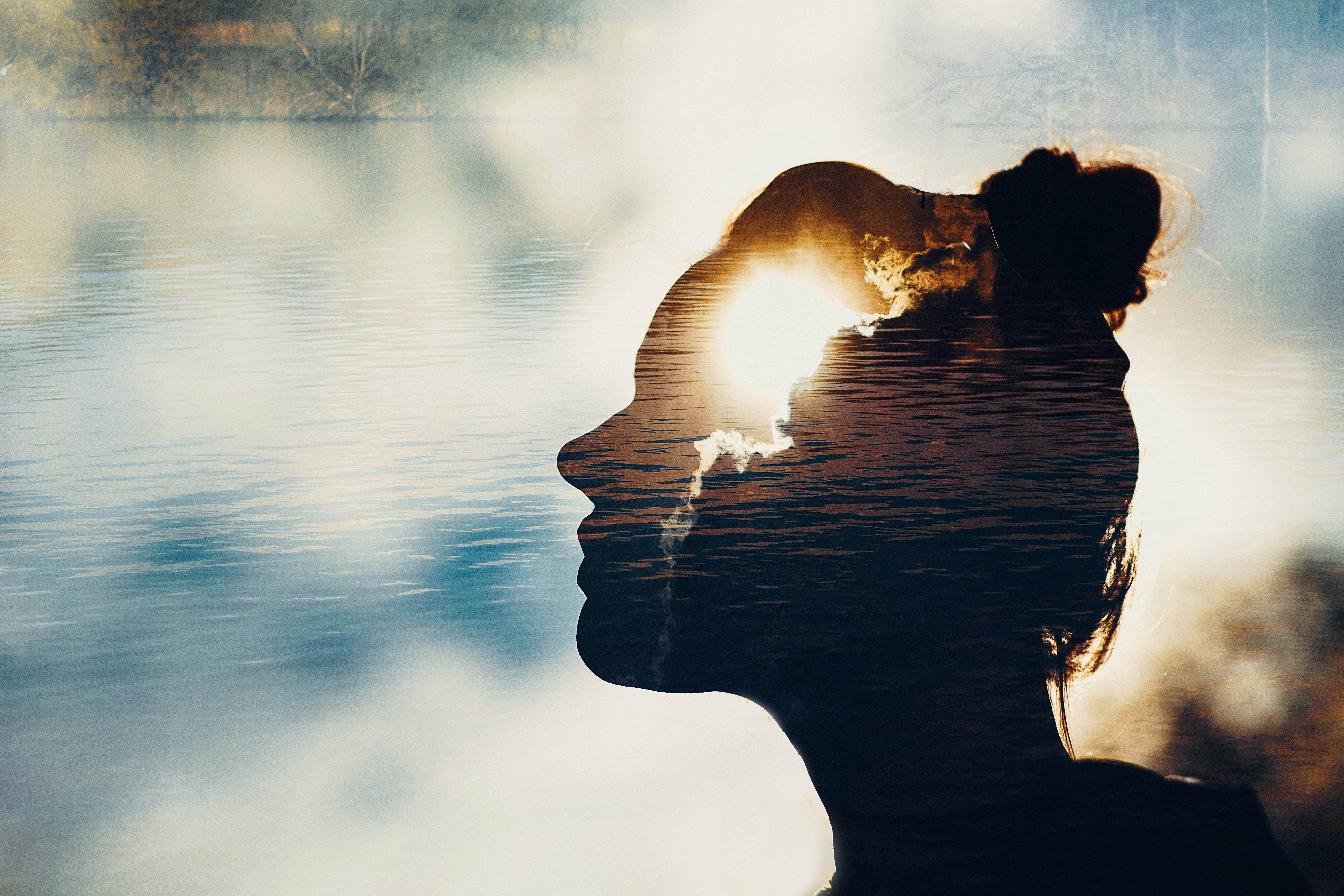 Silhouette of a woman with light focused on the forehead/brain portion of the silhouette